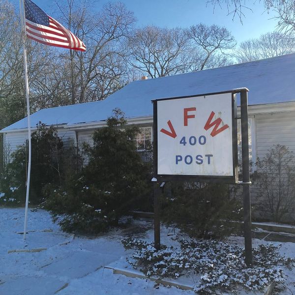 Snow on the lawn beside the VFW Post 400 sign