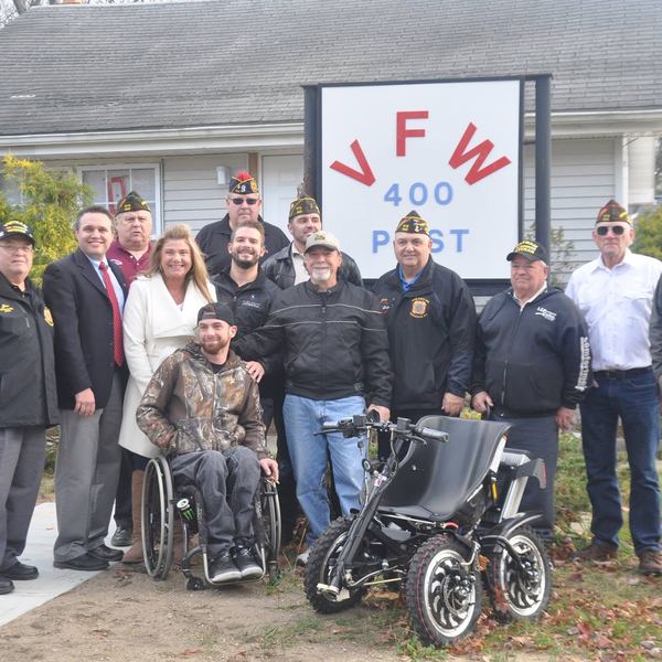 Members and guests including veterans in wheelchairs outside the Post