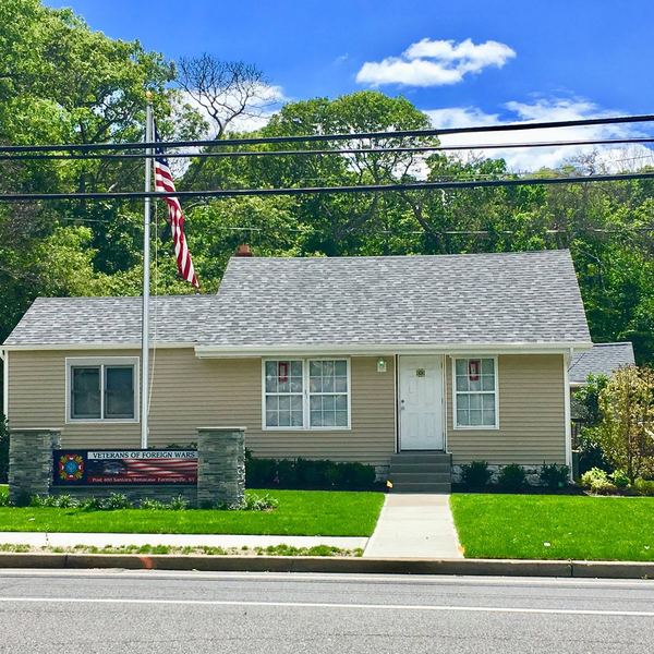 The renovated Post building with a flagpole and lawn