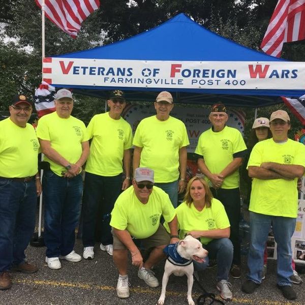 Members in matching yellow shirts under a VFW canopy