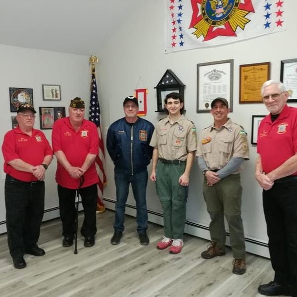 Post members standing with Scouts in uniform