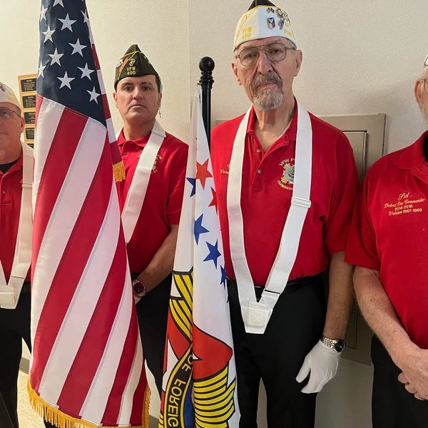 Members in VFW caps holding flags