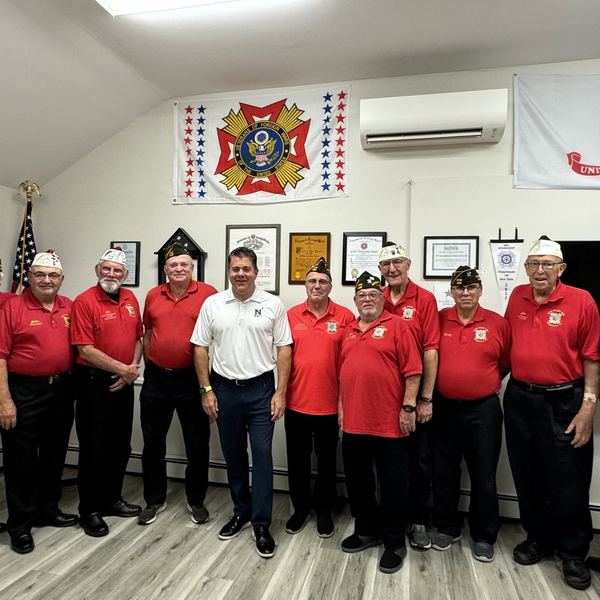 Members in red shirts in the Post meeting room
