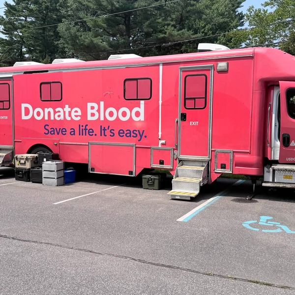 A mobile blood donation bus parked at the Post
